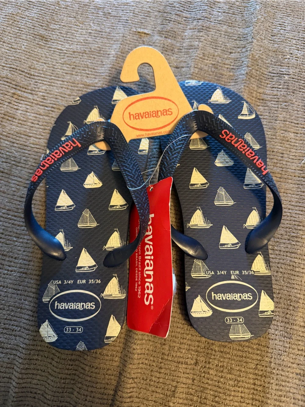 Havaianas Navy Blue Flip Flops with White Sailboat Print and Red Logo